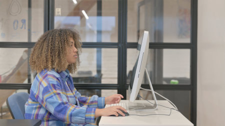 African Woman Working on Desktop in Office