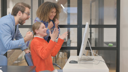 Mixed Race People Celebrating Success on Desktop