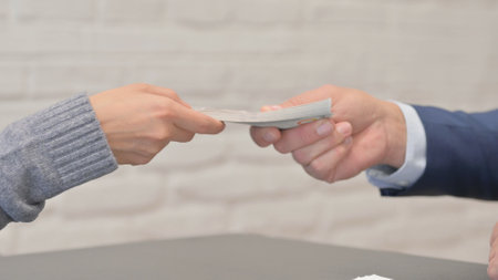 Close Up of Business People Giving Moneyの写真素材
