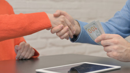 Close up of Woman Giving Money to Businessman