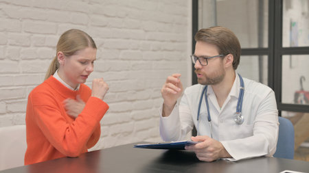 Coughing African Patient Discussing Health issues with Male Doctor
