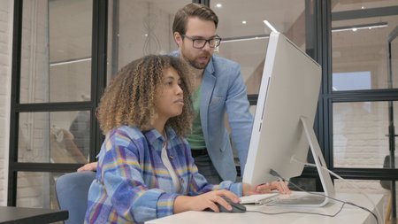 Young Entrepreneur Guiding Woman at Work