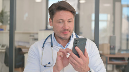 Portrait of Doctor Using Smartphoneの写真素材