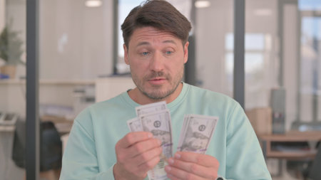 Portrait of Man Counting Money at Work