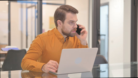 Angry Businessman in Argument while Talking on Phone