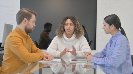 African Female Leader Talking with Multi Ethnic Teammates