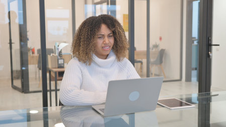 African American Woman Reacting to Loss on Laptop