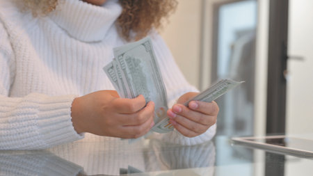 Close up of Female Hands Counting Moneyの写真素材