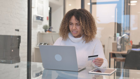 African Woman Upset with Online Shopping Failure on Laptopの写真素材