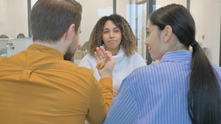 African Real Estate Agent Giving Home Keys to Coupleの写真素材