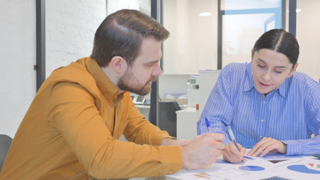Angry Woman in Argument with Teammate while Discussing Documents