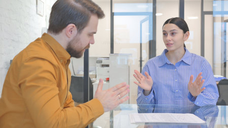 Businessman Talking with female Worker in Office
