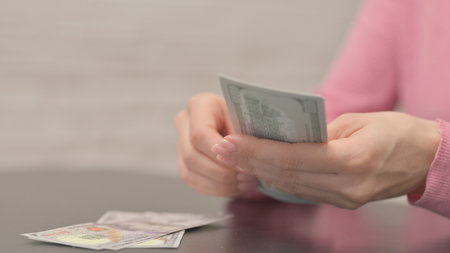Close up of Female Hand Counting Moneyの写真素材