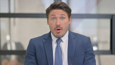 Portrait of Middle Aged Businessman Reacting to Failureの写真素材