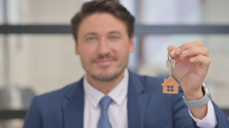 Close up of Home Keys in Hands of Real Estate Agentの写真素材