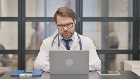 Doctor Doing Video Chat on Laptop in Hospitalの写真素材