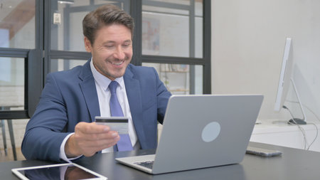 Mature Adult Businessman Satisfied with Online Banking Payment