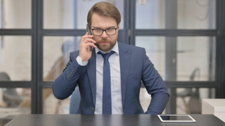 Young Businessman Talking on phoneの写真素材