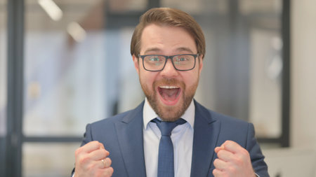 Portrait of Middle Aged Businessman Celebrating Successの写真素材