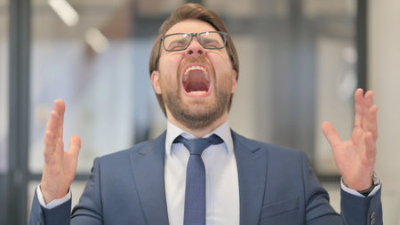 Portrait of Angry Middle Aged Businessman Screaming and Shouting