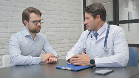 Mature Adult Doctor Talking with Tense Manの写真素材