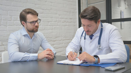 Mature Adult Doctor Writing Medicine for Patientの写真素材