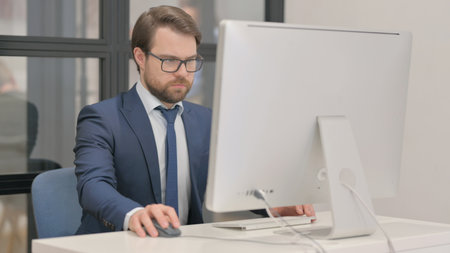 Young Businessman Working on Computer in Officeの写真素材
