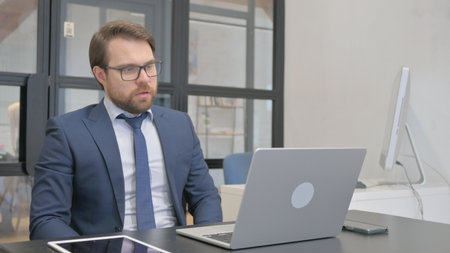 Losing Businessman having Emotional Stress at Workの写真素材