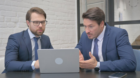 Businessmen Reacting to Online Investment Lossの写真素材