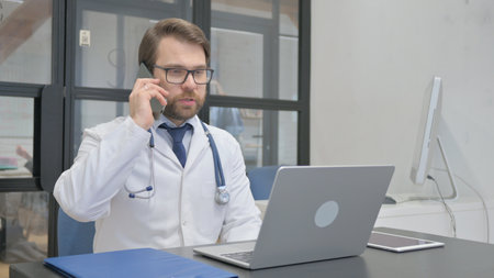 Mature Adult Doctor Talking on Phoneの写真素材