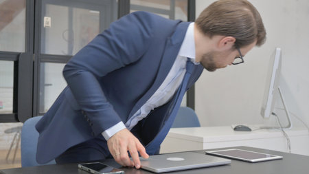 Businessman Leaving Office after Finishing Workの写真素材