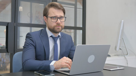 Young Businessman Using Laptopの写真素材