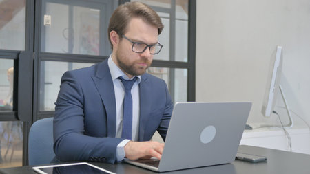 Young Businessman Working on Laptopの写真素材