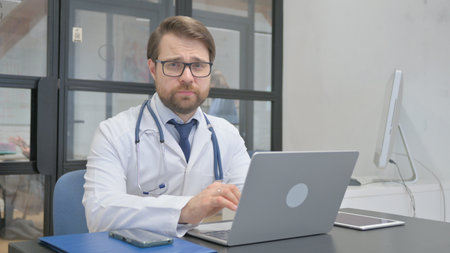 Stopping Mature Adult Doctor Restricting Patient while working on Laptopの写真素材