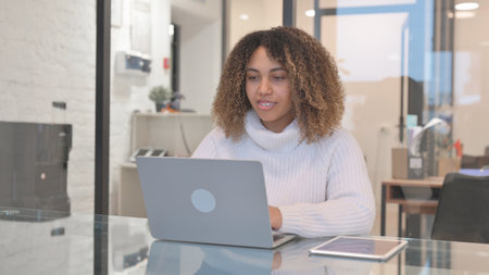 African Woman Doing Video Chat in Officeの写真素材