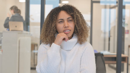Portrait of Pensive African Woman Thinking New Ideaの写真素材
