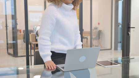 Tired African American Woman Leaving Office Deskの写真素材