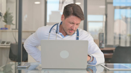 Mature Adult Doctor having Back Painの写真素材