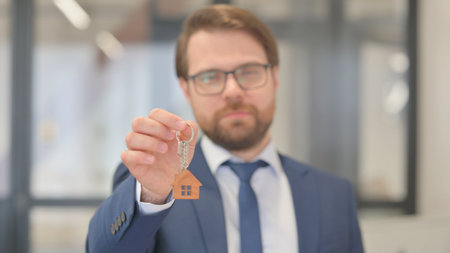 Close up of Home Keys in Hands of Real Estate Agentの写真素材