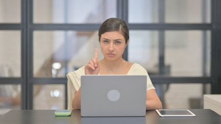 Denying Young Indian Woman Rejecting while Using Laptop