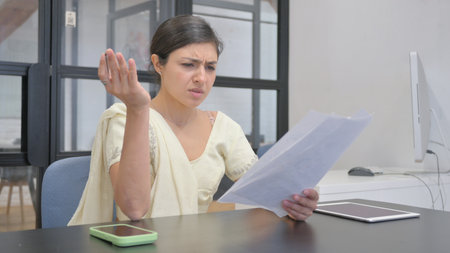 Indian Woman Shocked while Reading Documentsの写真素材