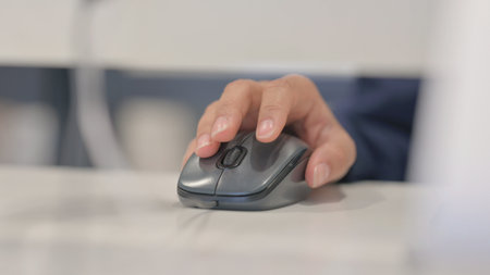 Close up of Woman Using Computer Mouse for Workの写真素材