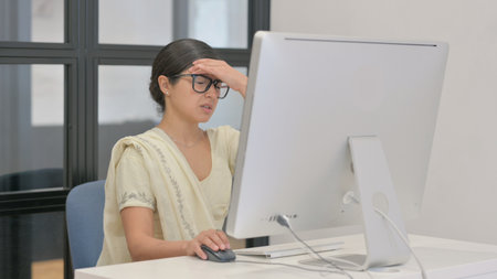 Young Indian Woman with Migraine Working on Desktop