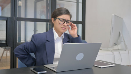 Indian Businesswoman with Back Pain in Office