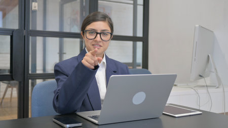 Indian Businesswoman Pointing at Camera at Workの写真素材