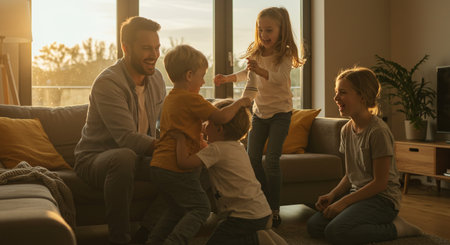 Happy family playing together at home. Mother, father and children having fun together.の素材