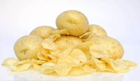 fresh potato's surrounded by fried chipsの写真素材