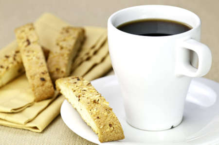 A cup of coffee and a readitional biscottiの写真素材