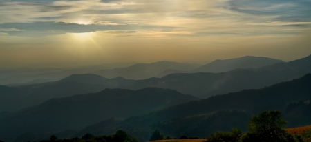 sun hides behind the clouds just before the sunset and last shine raysの写真素材