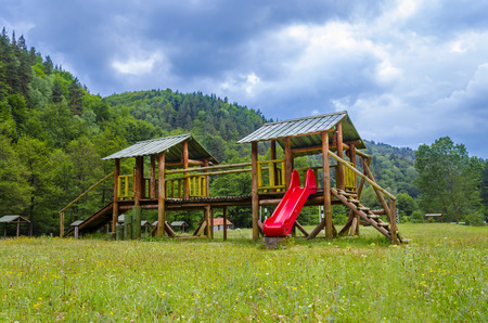 Wooden modern children playground in nature parkの写真素材